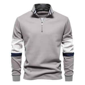 Gray zip-neck sweatshirt with colorblock sleeves and striped collar.