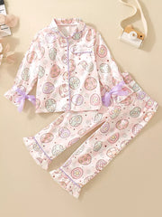 Toddler pink button-down pajama set with pastel egg print and purple trim.