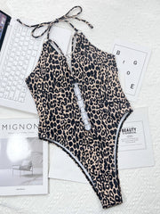 Leopard print one-piece swimsuit with ring detail and halter neck.