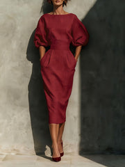 Wine red midi dress with puff sleeves, boat neck, and pockets.