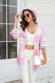 Open knit cocoon cardigan with rainbow stripes in pink, blue, and yellow acrylic.