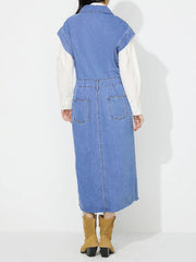 Sleeveless light wash denim midi dress with buttoned front, slit, and frayed hem.