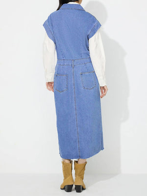 Sleeveless light wash denim midi dress with buttoned front, slit, and frayed hem.