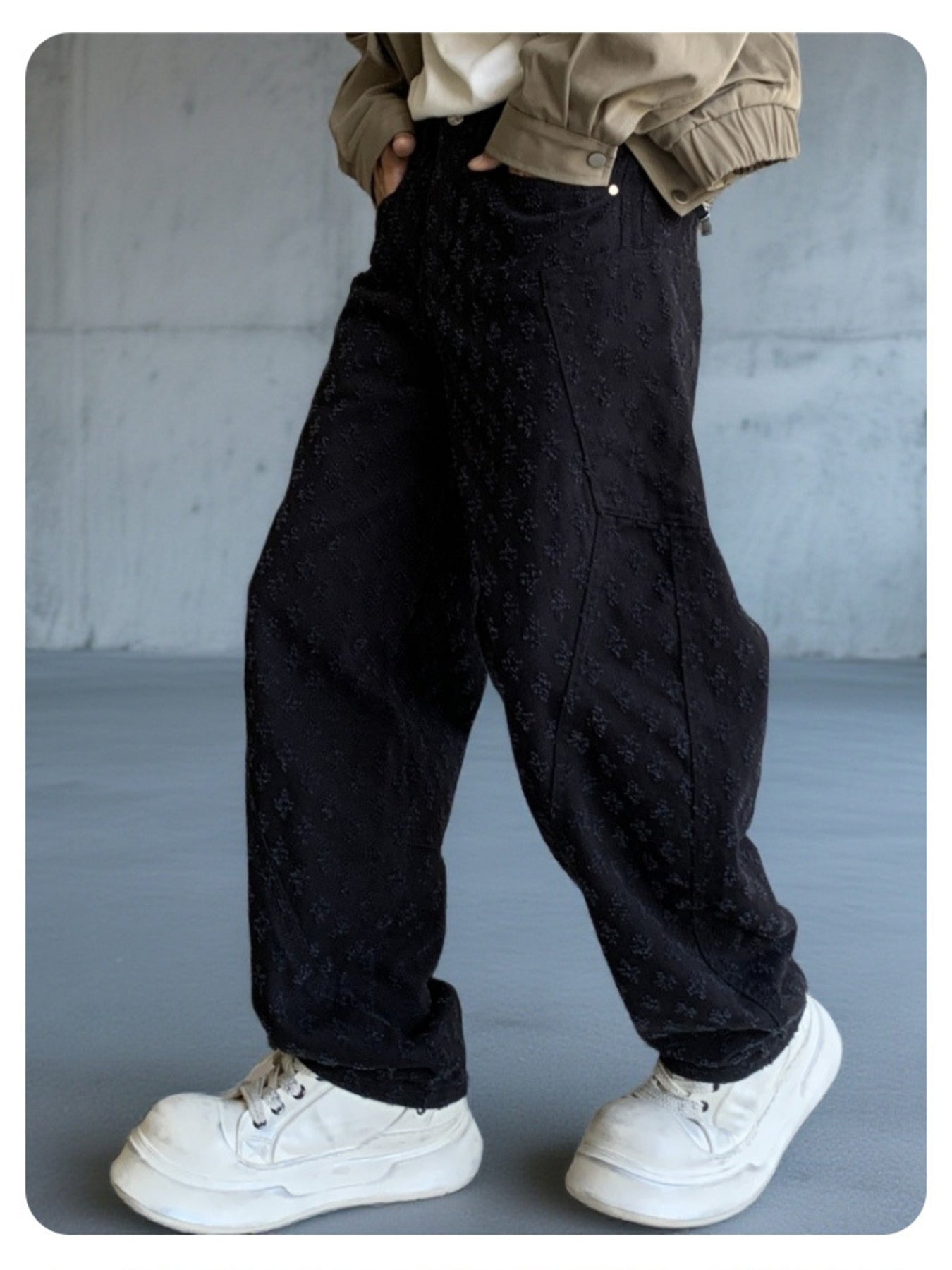 Black textured cotton wide-leg jeans for men with curved seams.