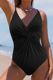 Black twisted front plunge one-piece swimsuit with a deep V-neckline.