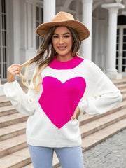 White acrylic sweater with a large pink heart intarsia and pink neckline.