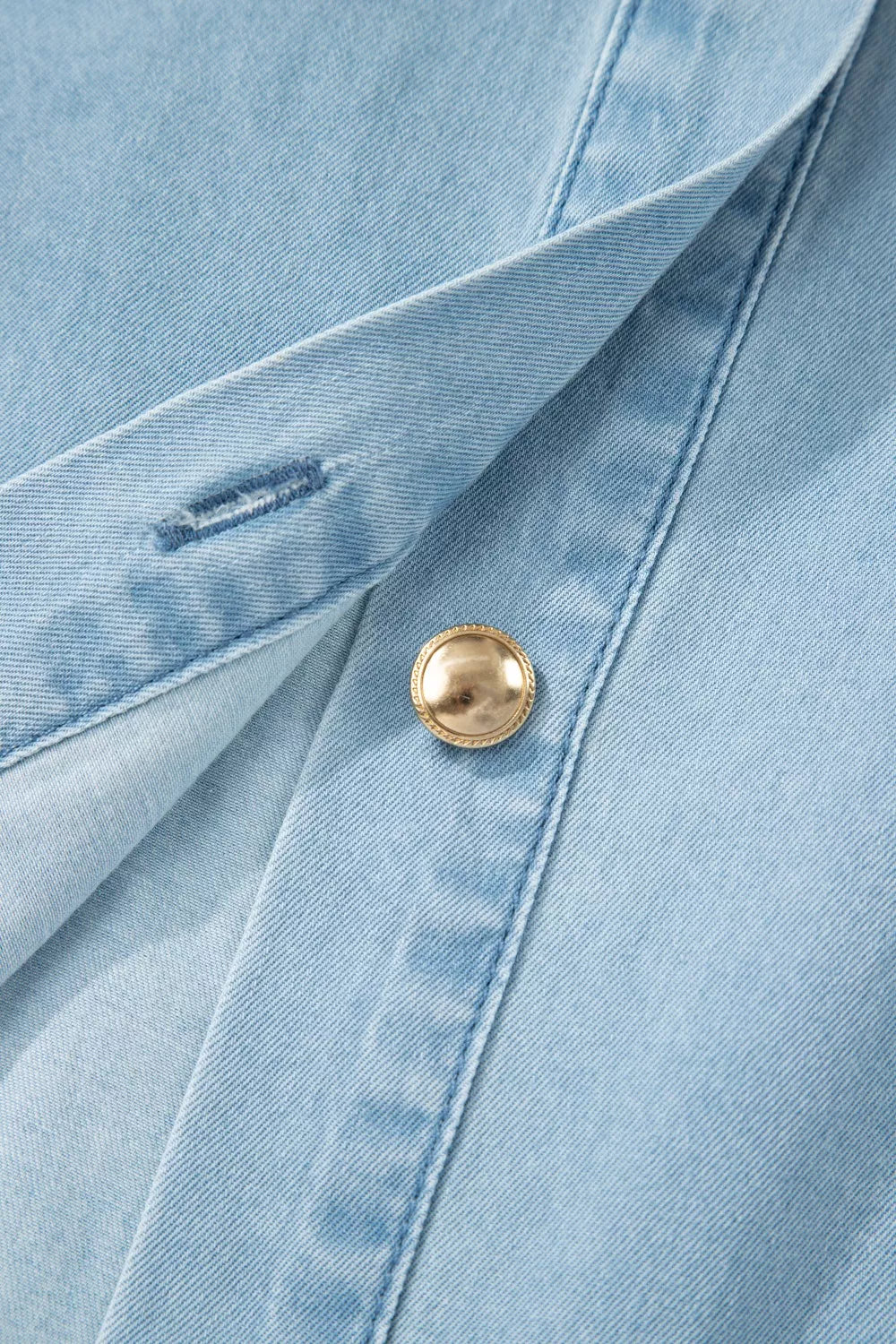 Light blue denim dress with a collared neckline, button front, and gold button detail.