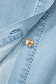 Light blue denim dress with a collared neckline, button front, and gold button detail.