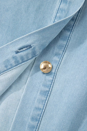 Light blue denim dress with a collared neckline, button front, and gold button detail.