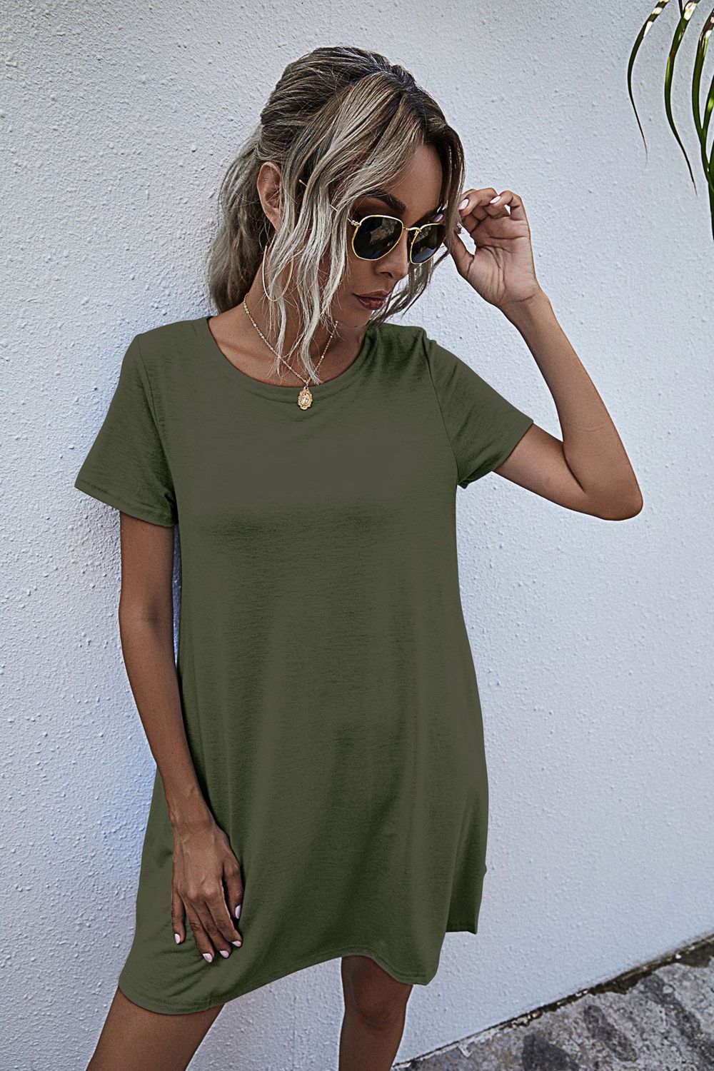 Army green relaxed t-shirt dress with short sleeves and pockets, crew neck.