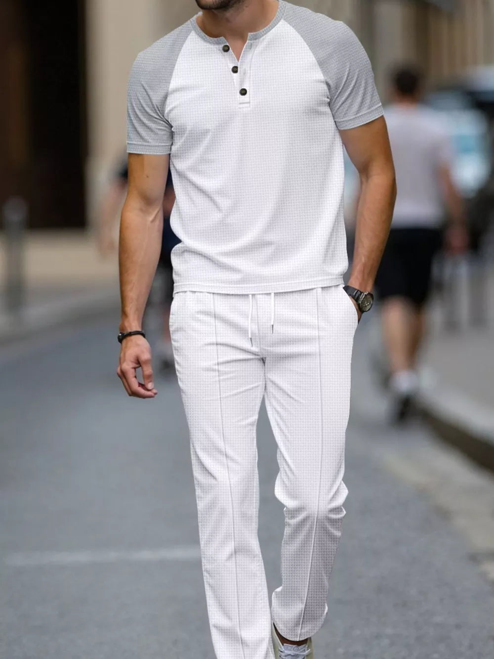 Men's white loungewear set with grey raglan sleeves and drawstring pants.