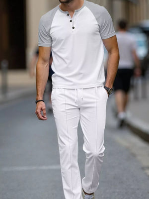 Men's white loungewear set with grey raglan sleeves and drawstring pants.