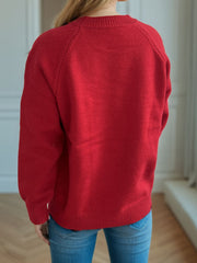 Burgundy embroidered floral raglan knit sweater with crew neck and ribbed cuffs and hem.