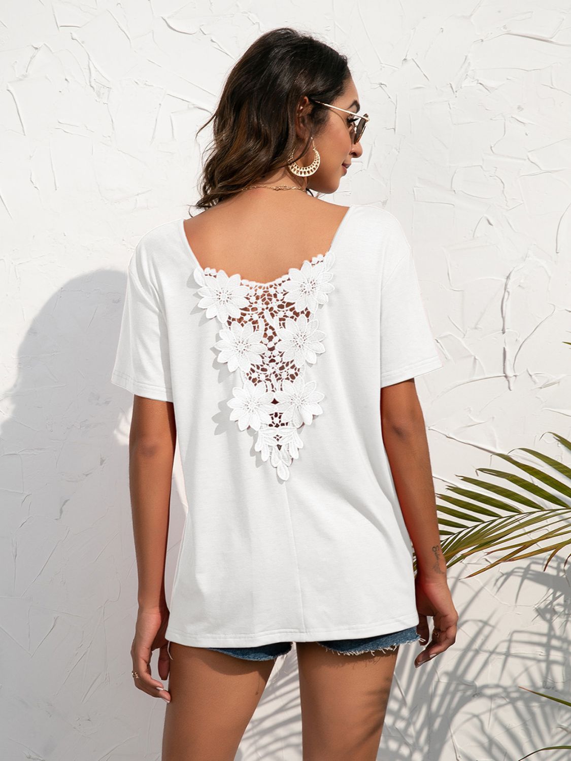 White t-shirt with floral lace detail on the back