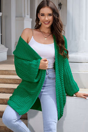 Mid green textured knit cocoon cardigan with balloon sleeves and open front.