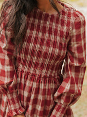 Red and cream plaid cotton mini dress with smocked bodice and puff sleeves.