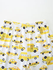 Toddler pajama set with yellow cartoon car print on white fabric, elastic waistband.