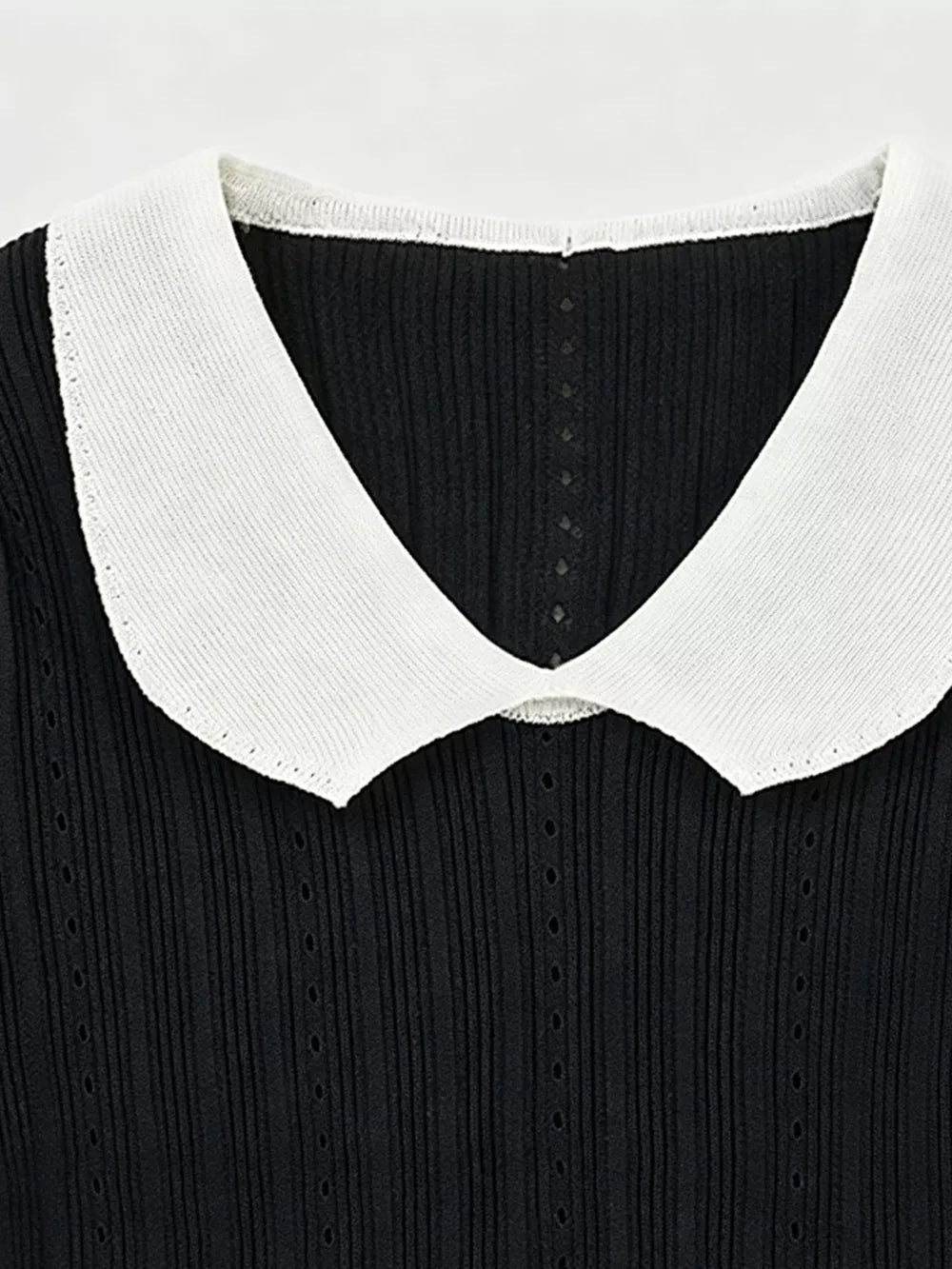 Black maternity t-shirt with white frill collar and ribbed texture.