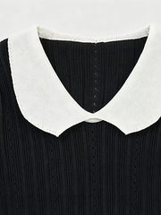 Black maternity t-shirt with white frill collar and ribbed texture.