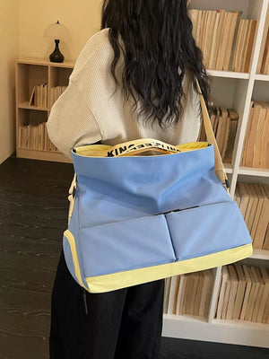 Blue Oxford cloth travel bag with yellow trim and exterior pockets.