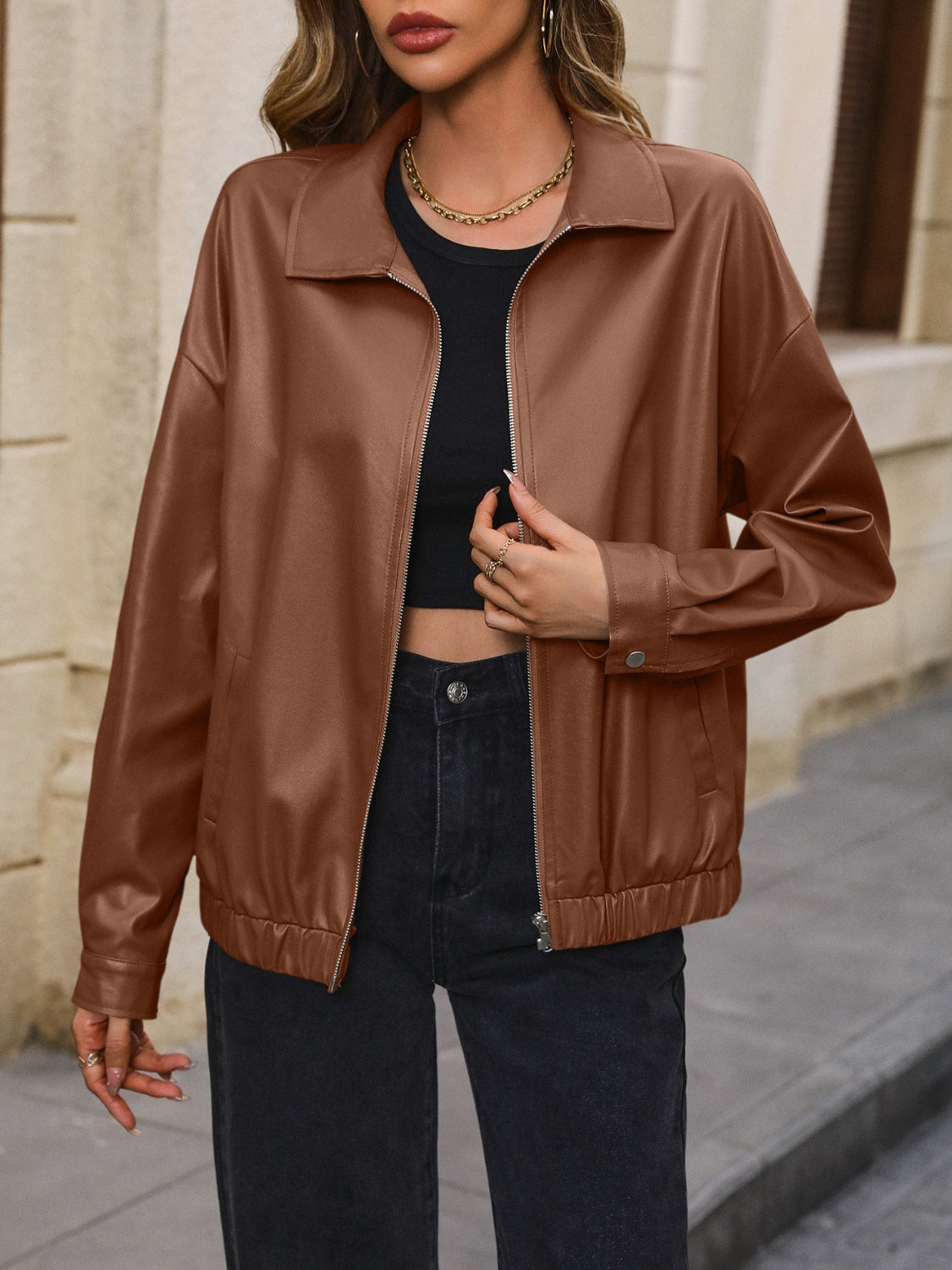 Brown faux leather bomber jacket with zip front and elastic cuffs