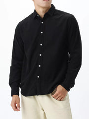 Black long sleeve buttoned shirt with a classic collar.