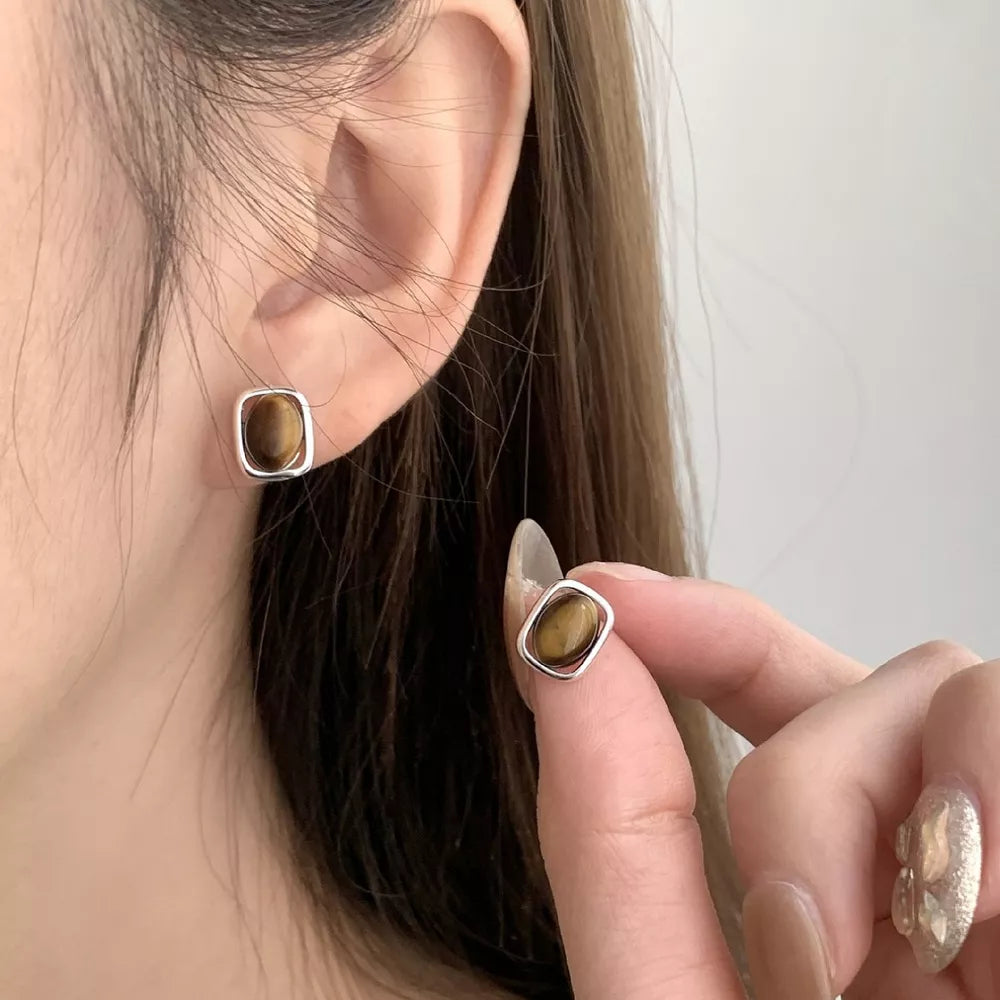 Polished Tiger Eye Square Stud Earrings in silver with natural chatoyancy detail.