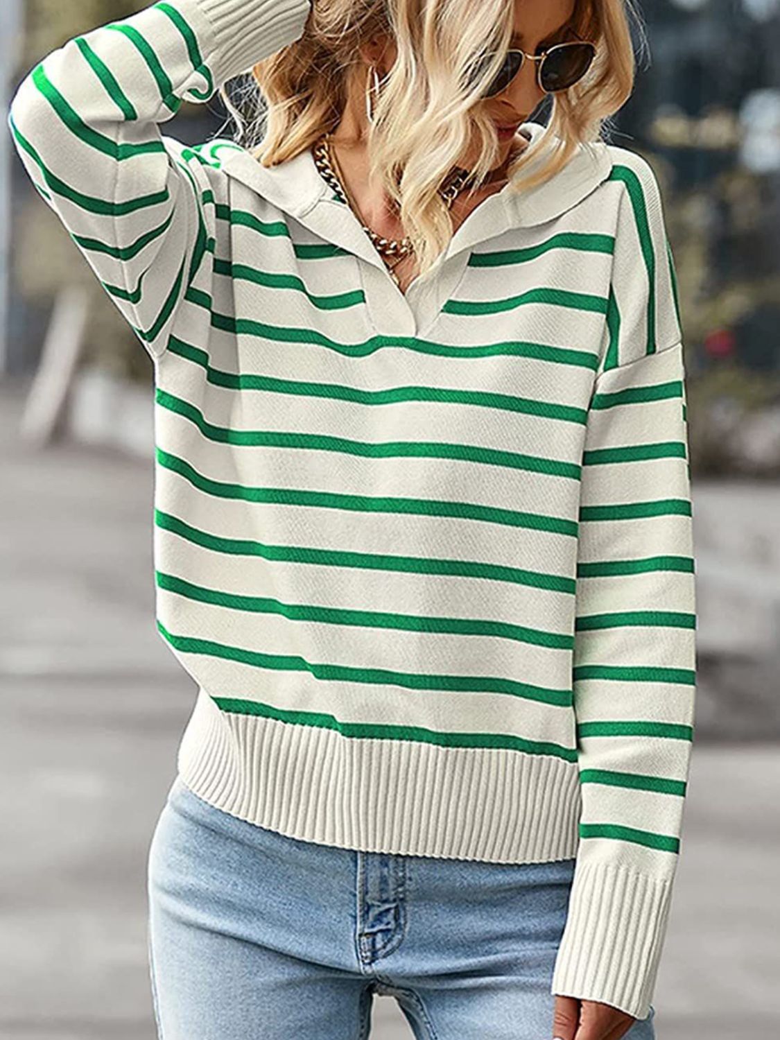 Striped polo knit sweater in cream with green stripes, featuring a collar and ribbed cuffs.