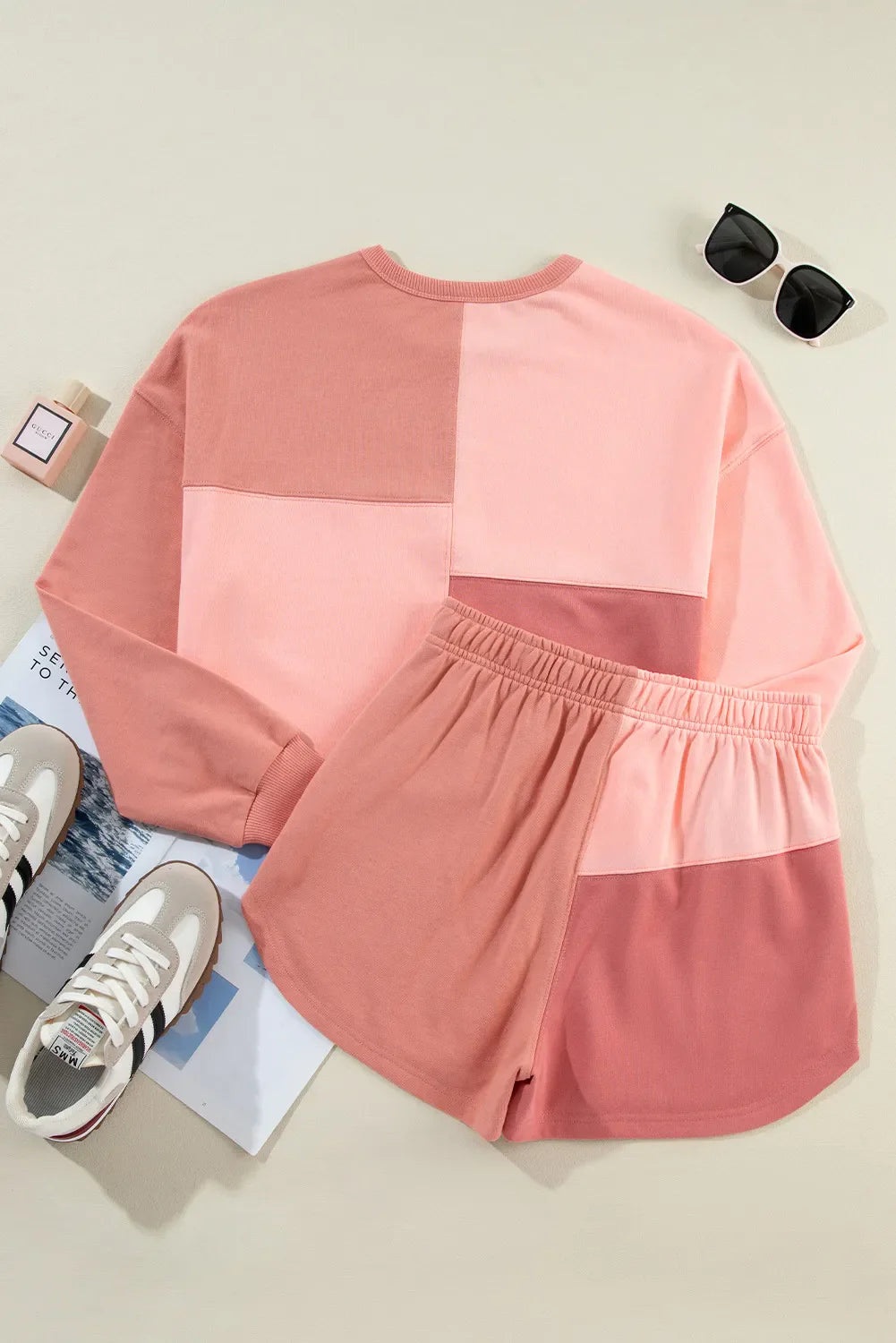 Colorblock lounge set with crewneck sweatshirt and elastic waist shorts in dusty pink and light blue.