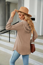 Textured henley hooded tunic in camel with long sleeves and a relaxed fit.