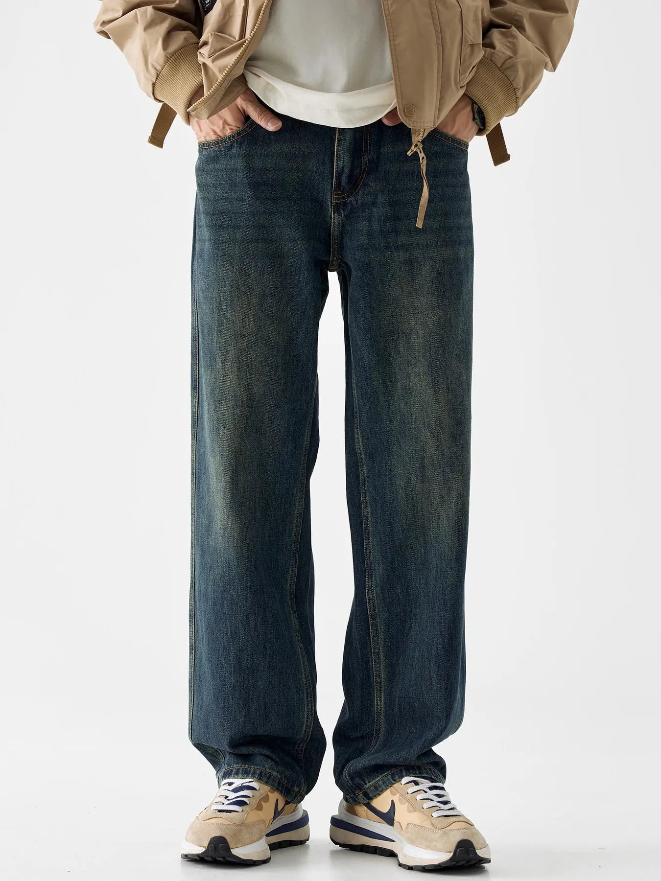 Loose fit blue cotton denim jeans with vintage wash and distressed details.