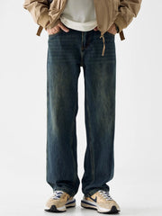 Loose fit blue cotton denim jeans with vintage wash and distressed details.