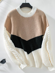 Chevron colorblock cable knit sweater in tan, black, and cream with cable knit sleeves.