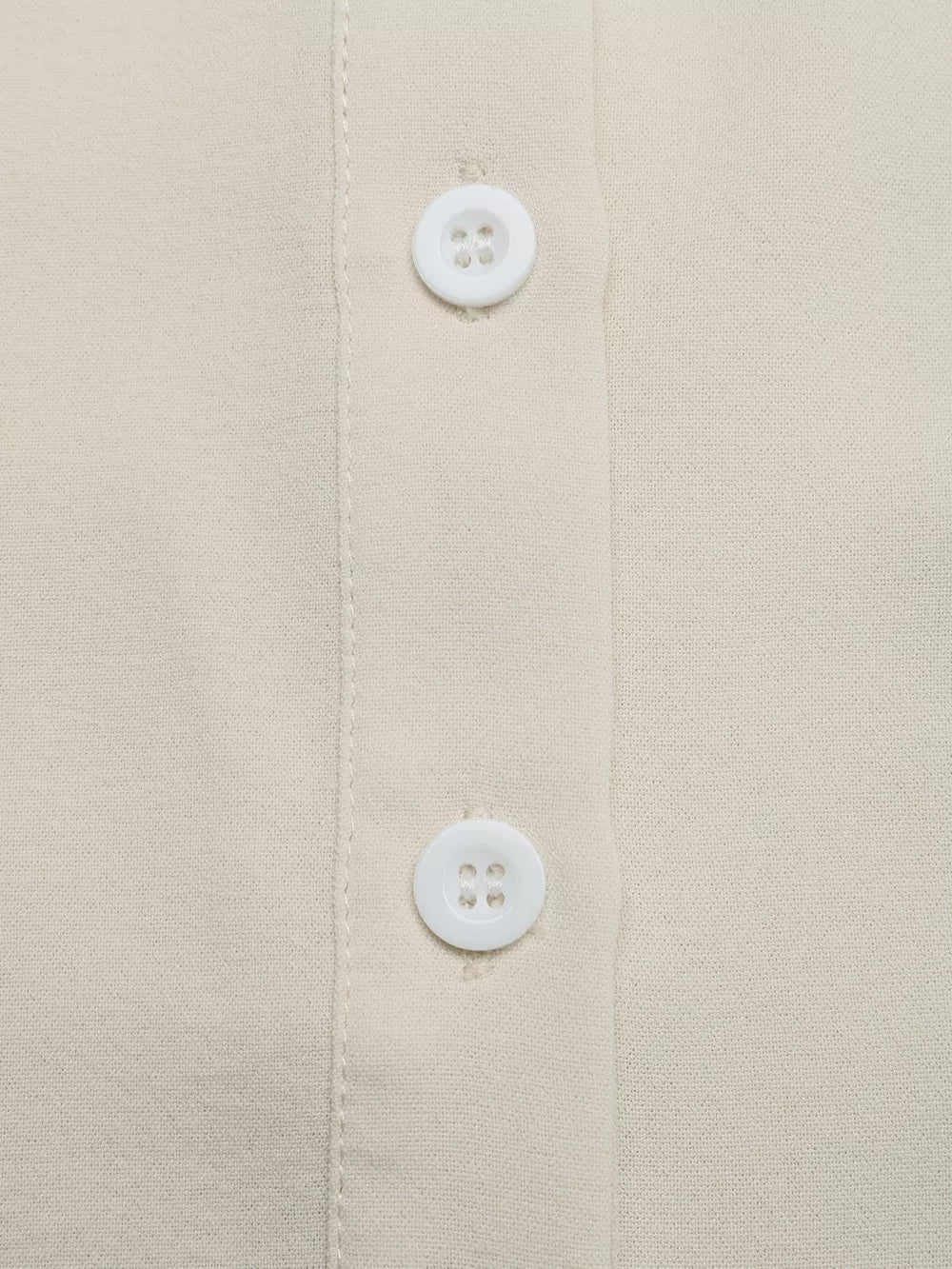 Beige button-down maternity overshirt with white buttons and subtle texture.