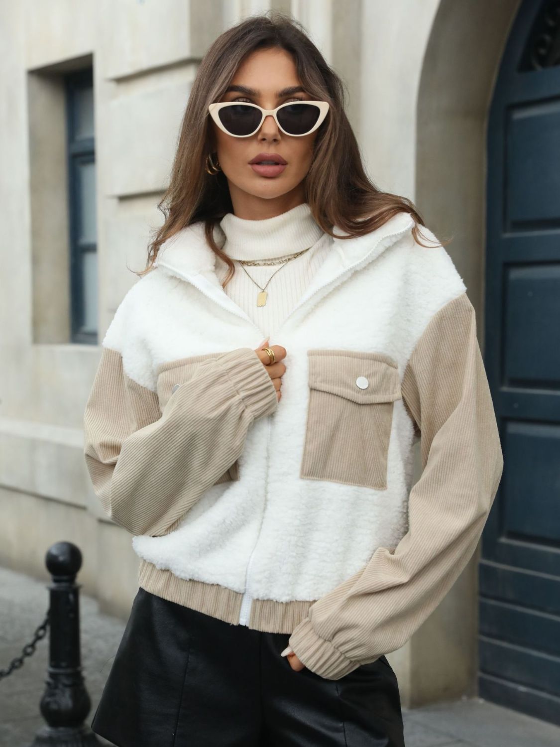 Colorblock sherpa and corduroy zip jacket in white with contrast tan sleeves and pockets.