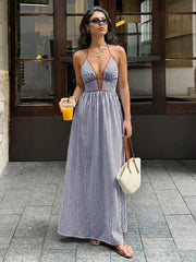 Striped halter neck maxi dress with plunging neckline and brown trim.