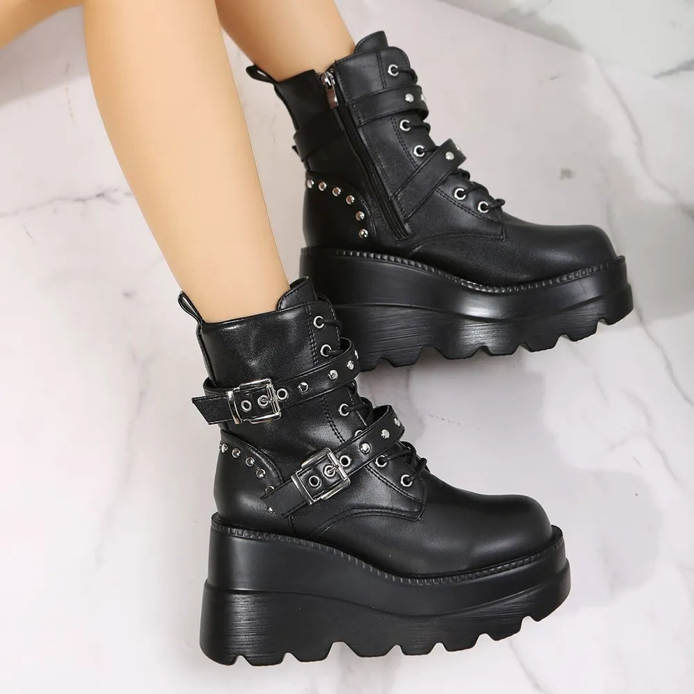 Black platform combat boots with buckles and stud details