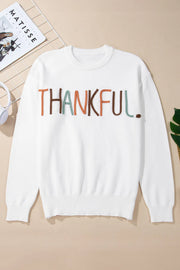 White crewneck sweater with embroidered "THANKFUL" text in multi-color yarn.