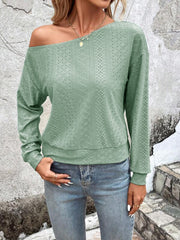 Light green off-shoulder eyelet knit blouse with long sleeves and a relaxed fit.