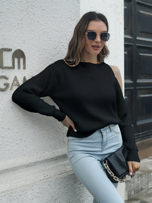 Black cold shoulder knit sweater with crew neck and long sleeves, made of acrylic.
