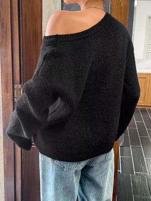 Black ribbed knit one-shoulder sweater with relaxed fit.