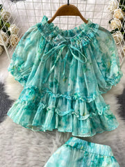 Light green tie-dye ruffle bikini top with bow detail and smocked neckline.