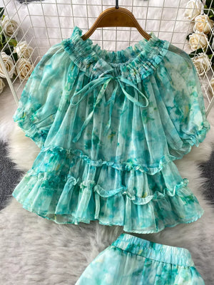 Light green tie-dye ruffle bikini top with bow detail and smocked neckline.
