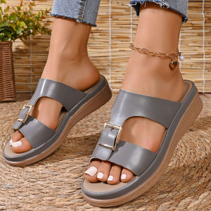 Sophisticated gray open-toe buckle sandals with a wedge heel.