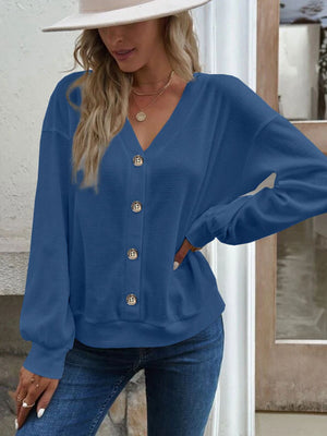 Blue waffle knit button-down cardigan with V-neck and wooden buttons.