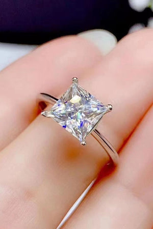 Silver ring with a bright princess cut solitaire diamond.