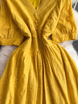 Yellow lace-embellished A-line midi dress with button front and puff sleeves.