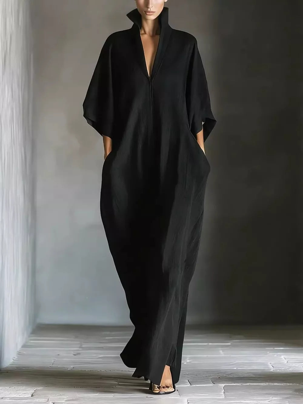 Black maxi dress with V-neck, short sleeves, and pockets.