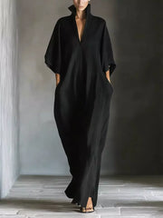 Black maxi dress with V-neck, short sleeves, and pockets.