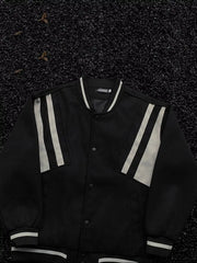 Black bomber jacket with white stripe accents on sleeves and collar, buttoned front.
